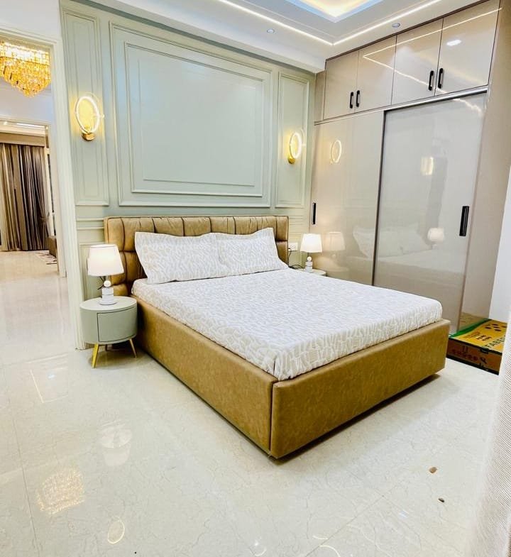 Modern 3BHK interior at Aggersen Enclave featuring vitrified tiles and false ceiling lighting