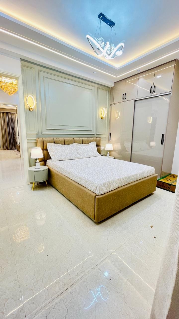 Modern 3BHK interior at Aggersen Enclave featuring vitrified tiles and false ceiling lighting