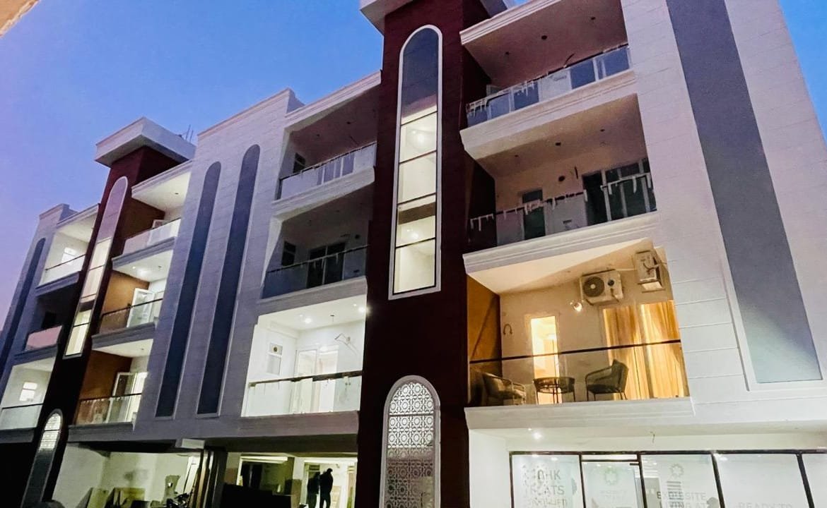 Gated community view of Aggersen Enclave Zirakpur with stilt parking and landscaped area"