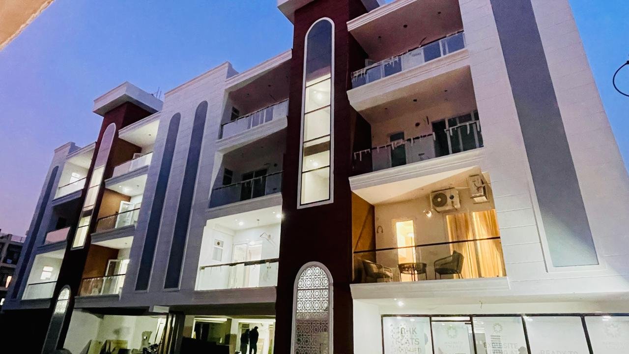 Gated community view of Aggersen Enclave Zirakpur with stilt parking and landscaped area"