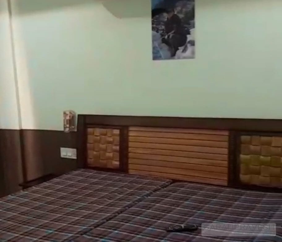 Fully furnished master bedroom with bed and wardrobe in ready-to-move 4BHK flat Zirakpur