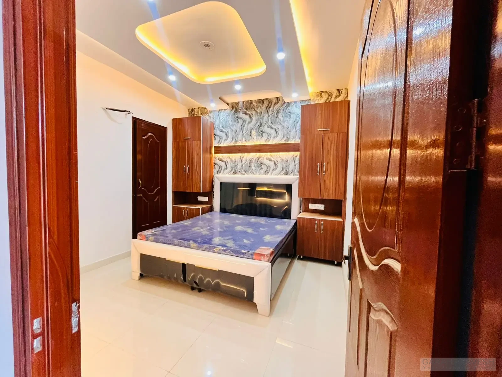 Master bedroom with premium wooden wardrobe and designer lighting