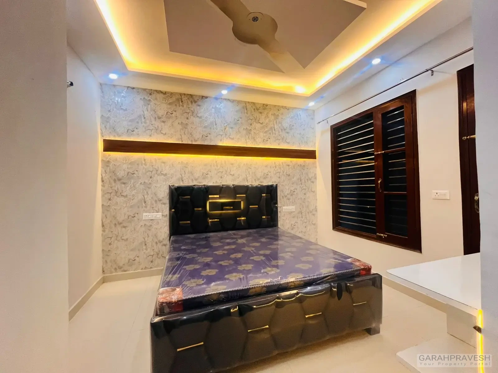 Master bedroom with premium wooden wardrobe and designer lighting