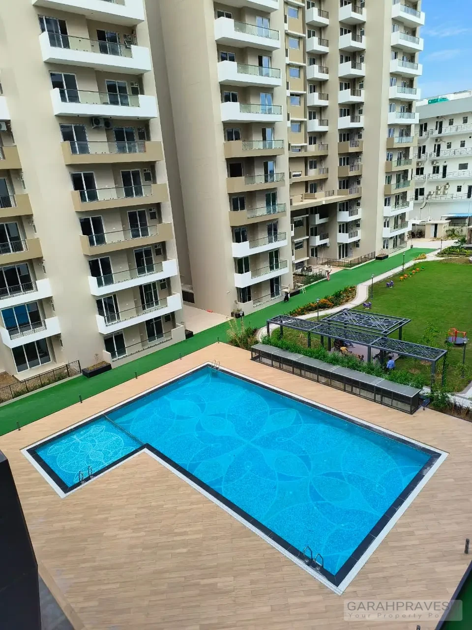 swimming pool at Uptown Skylla surrounded by lounge chairs and palm trees" "State-of-the-art gymnasium with premium equipment in Uptown Skylla Zirakpur