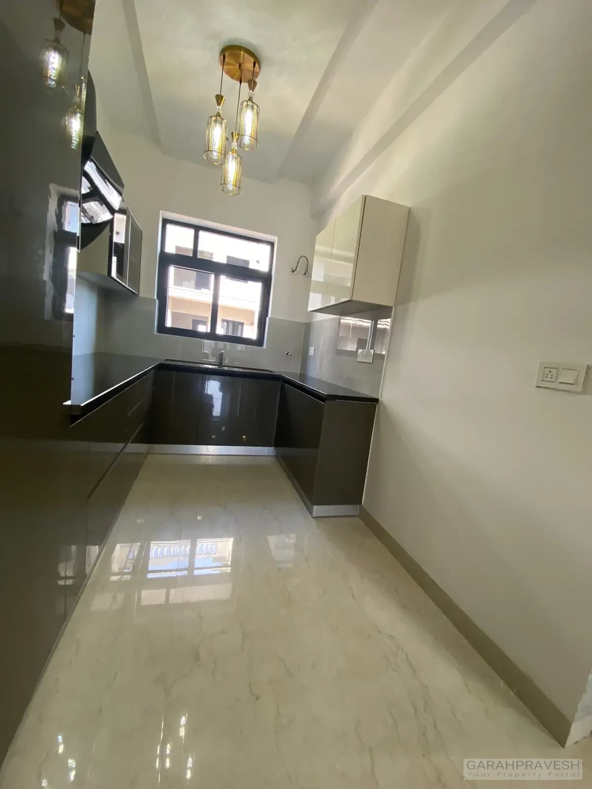 Modular kitchen space in 1600 sqft Motia Aero Greens apartment