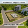 Aerial view of a 10 Marla residential plot in Aerocity Mohali H Block with greenery and modern infrastructure, featuring bold text overlay "10 Marla Plot | Aerocity Mohali